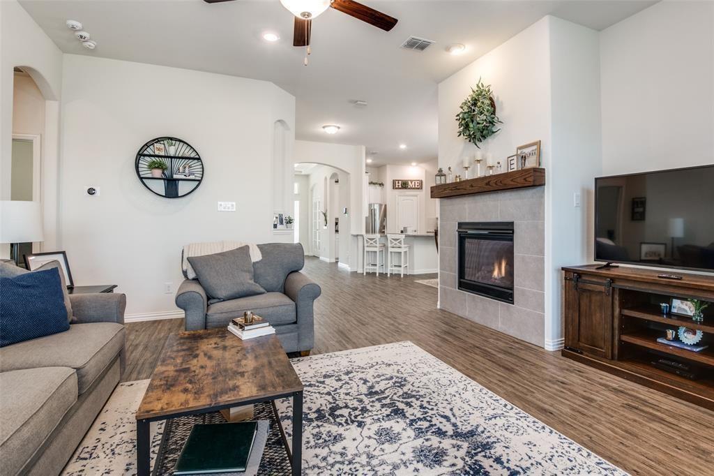 14845 Gilley Lane Fort Worth, TX 76052 - Photo 28 of 35 a living room with furniture a flat screen tv and a fireplace