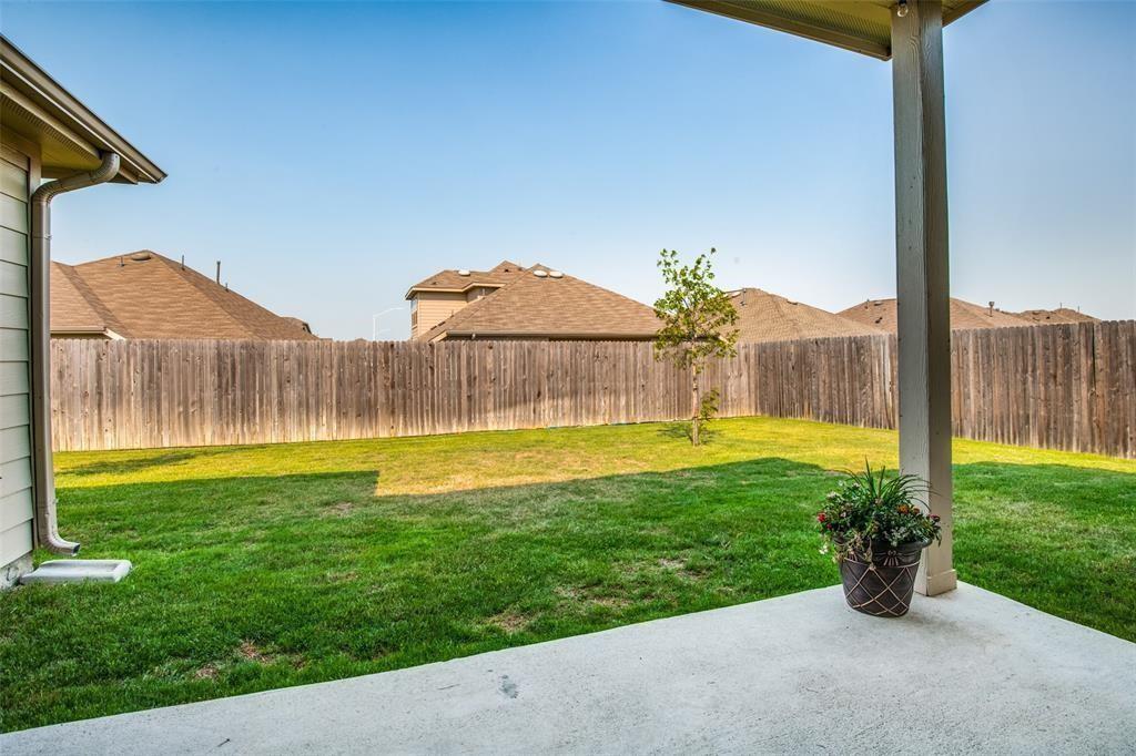 14845 Gilley Lane Fort Worth, TX 76052 - Photo 5 of 35 a view of a house with a yard and a table and chairs