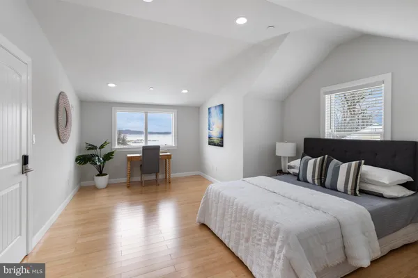 a bedroom with a bed and a painting on the wall