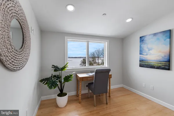 a bedroom with bed furniture and a large window