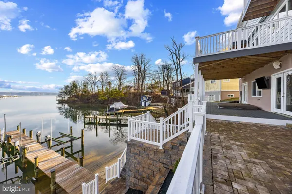a view of backyard with a deck and wooden floor