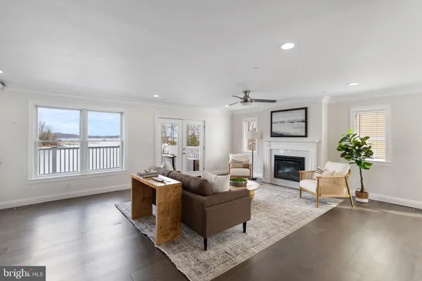a living room with furniture and a view of kitchen