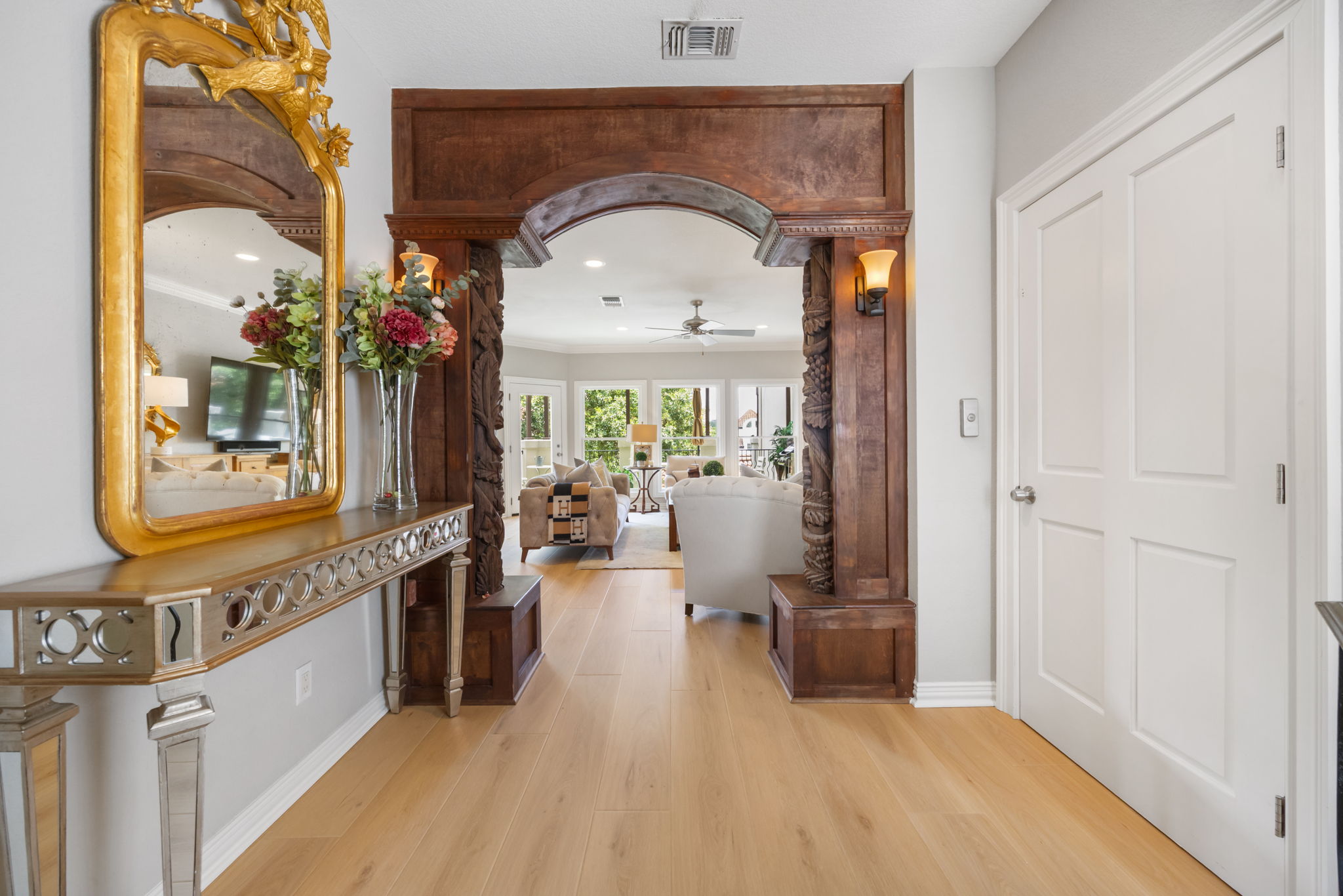 1910 Rue De St Tropez, Unit 6 Austin, TX 78746 - Photo 5 of 37 A grand carved archway and golden mirror welcomes you into this inviting living space with bright outdoor views.