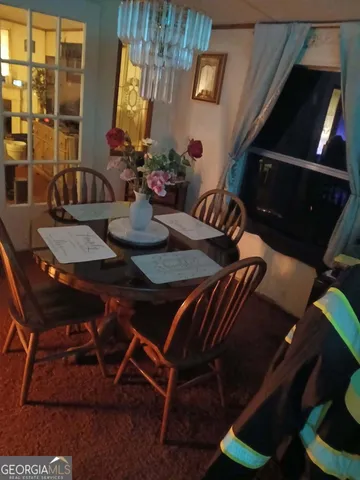 a view of a dining room with furniture and chandelier