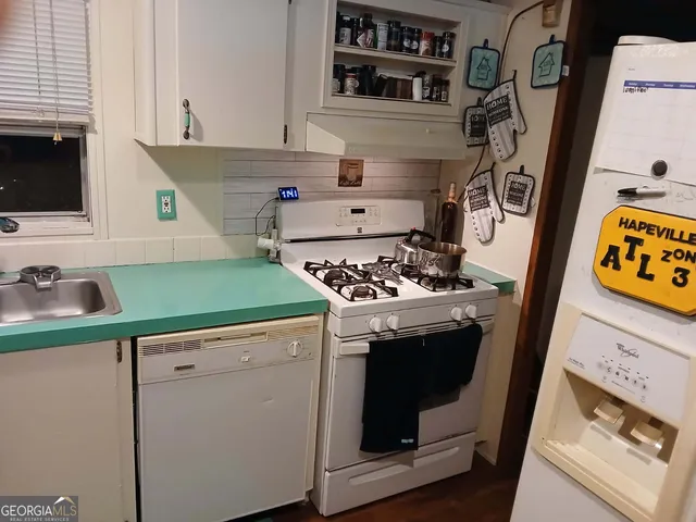 a kitchen with stainless steel appliances granite countertop a stove and a sink