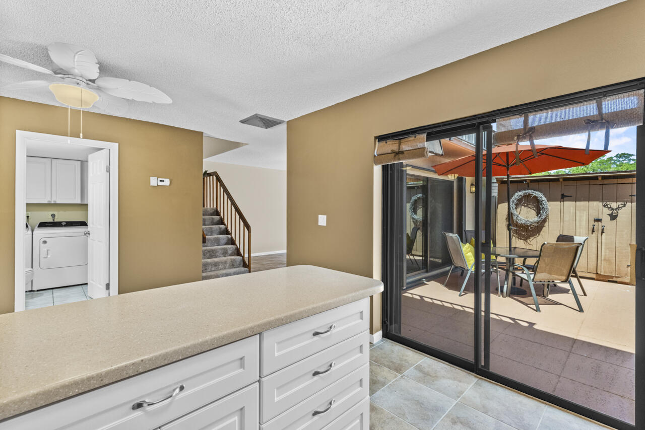 6025 Southeast Riverboat Drive, Unit 811 Stuart, FL 34997 - Photo 16 of 37 a spacious bathroom with a granite countertop sink a mirror and a shower