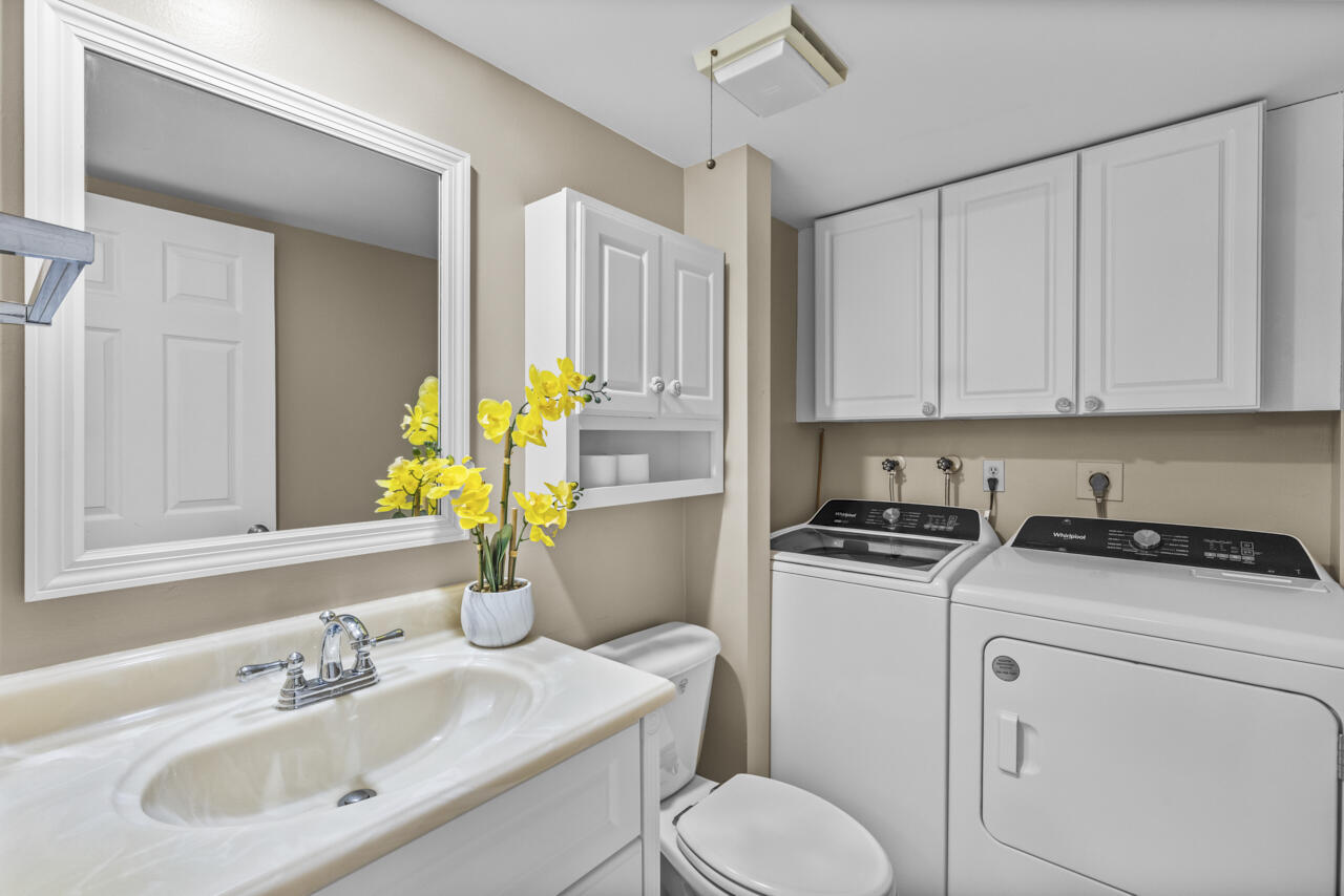 6025 Southeast Riverboat Drive, Unit 811 Stuart, FL 34997 - Photo 17 of 37 a bathroom with a sink a toilet and vanity