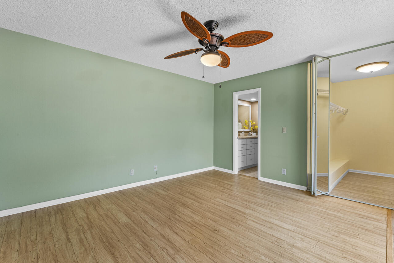 6025 Southeast Riverboat Drive, Unit 811 Stuart, FL 34997 - Photo 18 of 37 an empty room with wooden floor and windows