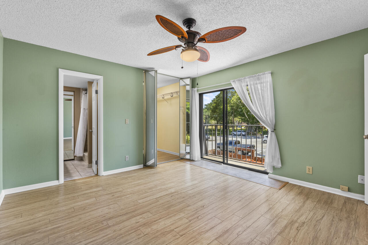 6025 Southeast Riverboat Drive, Unit 811 Stuart, FL 34997 - Photo 20 of 37 wooden floor in an empty room with a window