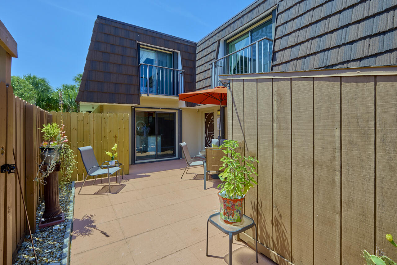 6025 Southeast Riverboat Drive, Unit 811 Stuart, FL 34997 - Photo 2 of 37 a view of a house with backyard and sitting area