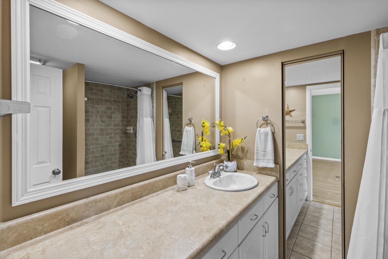 6025 Southeast Riverboat Drive, Unit 811 Stuart, FL 34997 - Photo 21 of 37 a bathroom with a sink double vanity and a mirror