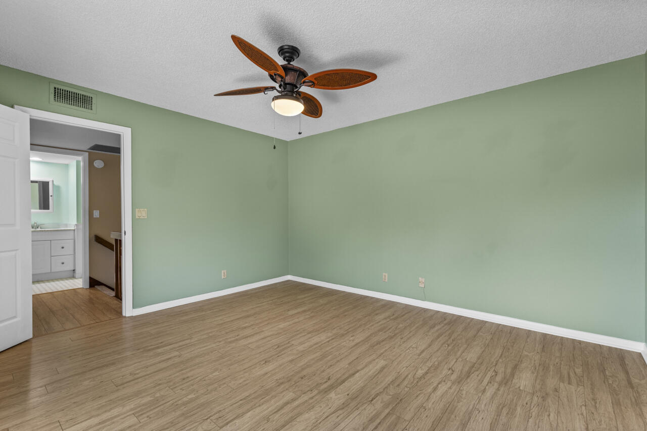 6025 Southeast Riverboat Drive, Unit 811 Stuart, FL 34997 - Photo 24 of 37 a view of a big room with wooden floor closet and windows