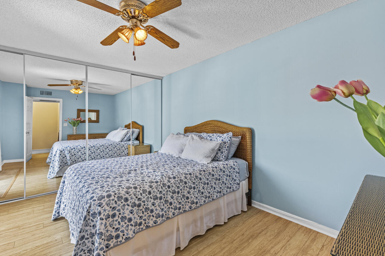 6025 Southeast Riverboat Drive, Unit 811 Stuart, FL 34997 - Photo 29 of 37 a bedroom with bed and a chandelier