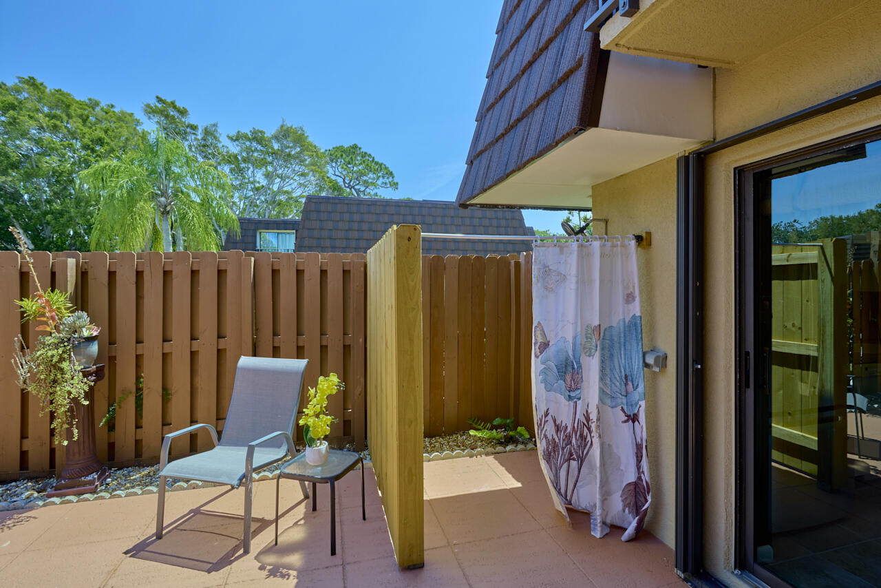 6025 Southeast Riverboat Drive, Unit 811 Stuart, FL 34997 - Photo 3 of 37 a view of a house with a backyard and a chair