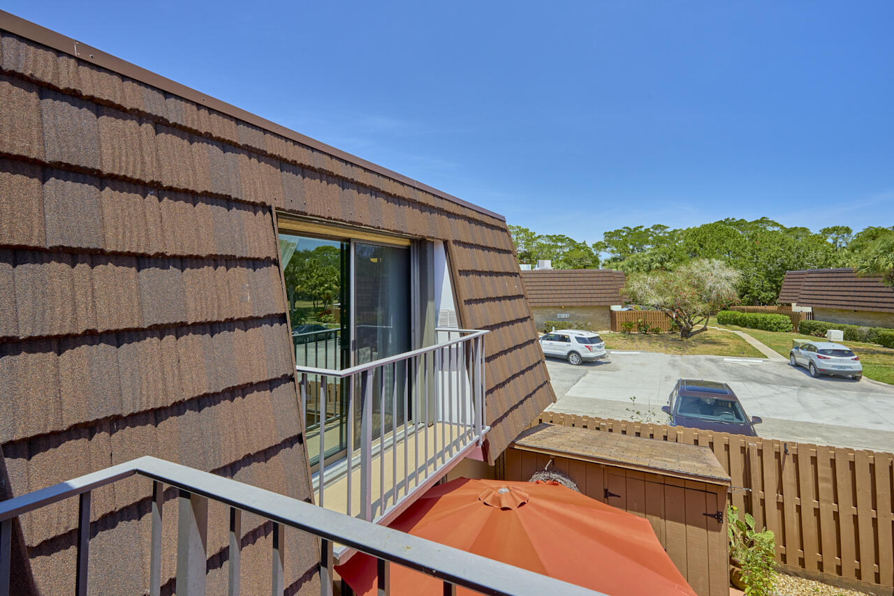6025 Southeast Riverboat Drive, Unit 811 Stuart, FL 34997 - Photo 33 of 37 a view of a balcony with two chairs and a table
