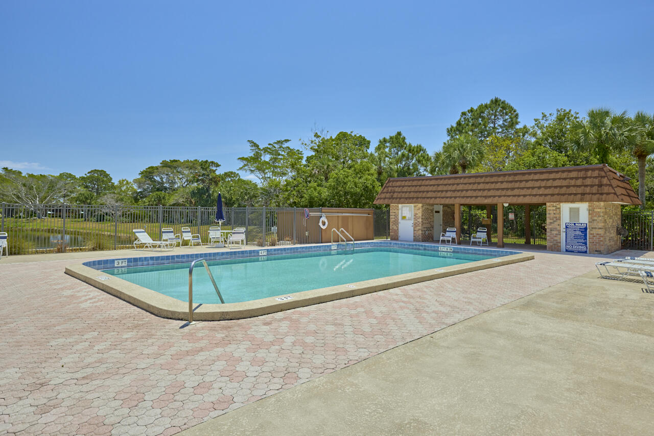 6025 Southeast Riverboat Drive, Unit 811 Stuart, FL 34997 - Photo 34 of 37 a view of a house with a swimming pool