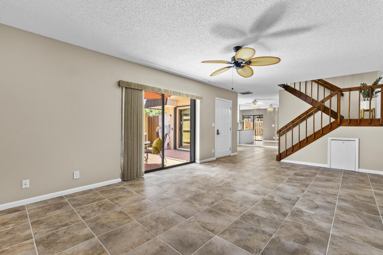 6025 Southeast Riverboat Drive, Unit 811 Stuart, FL 34997 - Photo 9 of 37 a view of a livingroom with furniture chandelier fan and windows