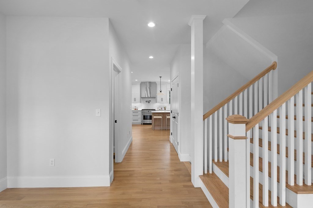 6 Rowell Road Middleton, MA 01949 - Photo 20 of 35 a view of a hallway with wooden floor kitchen and a chandelier