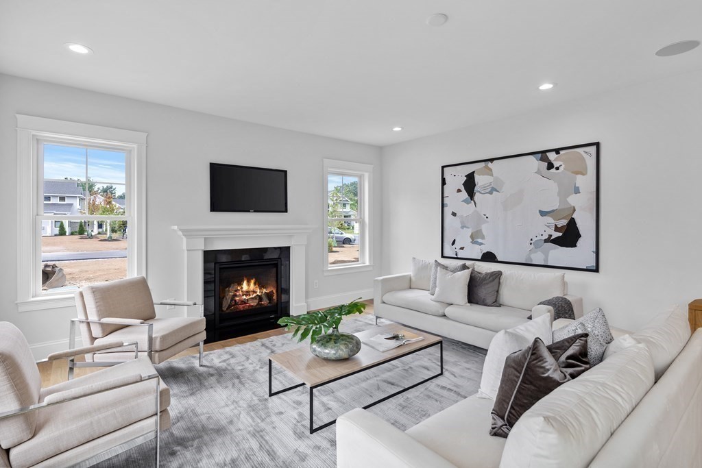 6 Rowell Road Middleton, MA 01949 - Photo 2 of 35 a living room with furniture a flat screen tv and a fireplace