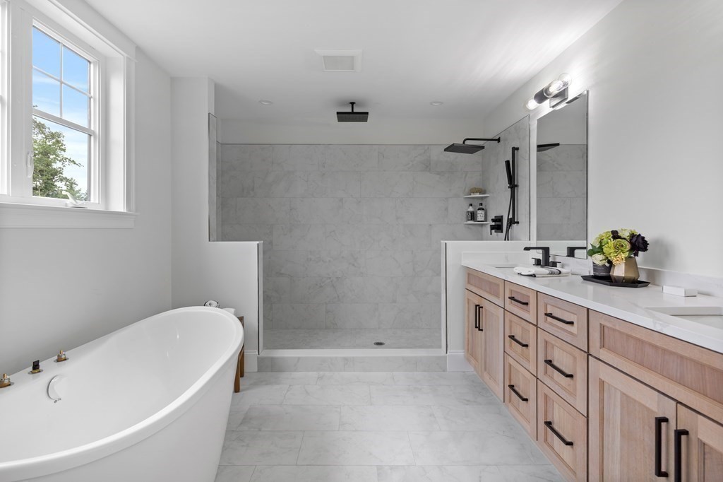 6 Rowell Road Middleton, MA 01949 - Photo 25 of 35 a bathroom with a tub sink and mirror