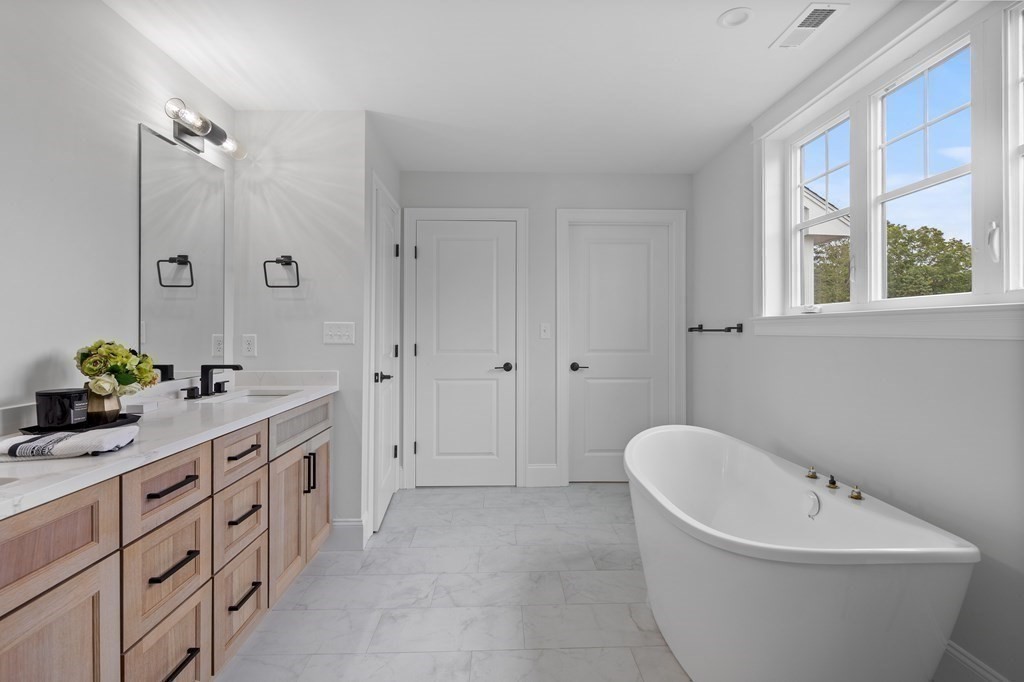 6 Rowell Road Middleton, MA 01949 - Photo 26 of 35 a spacious bathroom with a tub sink and mirror