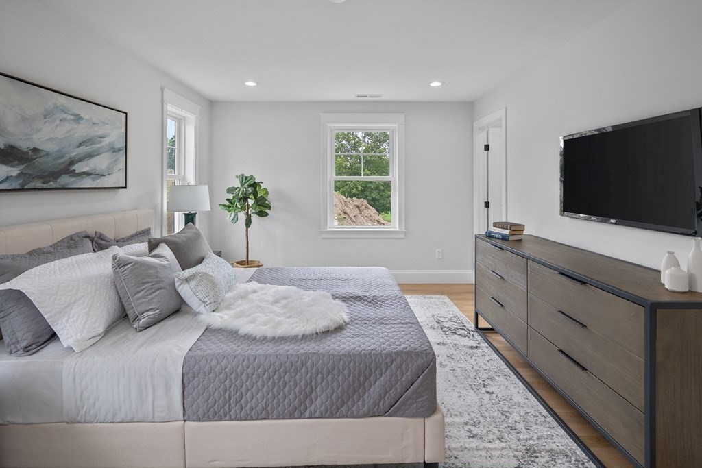 6 Rowell Road Middleton, MA 01949 - Photo 27 of 35 a bedroom with a large bed and a flat screen tv