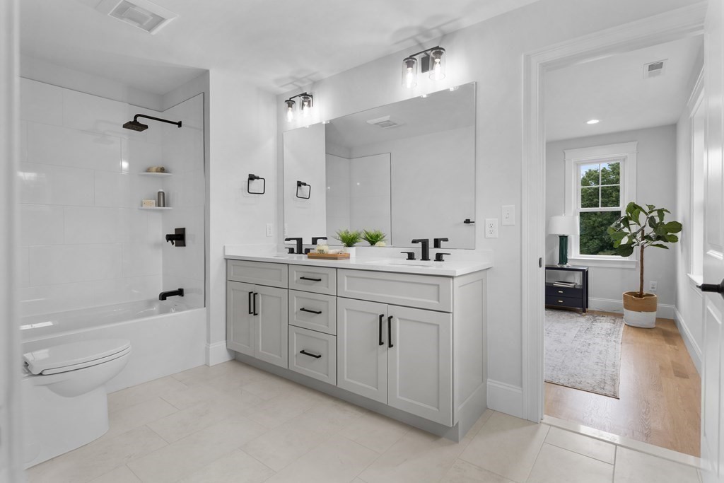 6 Rowell Road Middleton, MA 01949 - Photo 28 of 35 a spacious bathroom with double vanity a toilet a a mirror a bathtub and shower