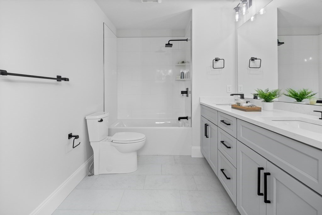6 Rowell Road Middleton, MA 01949 - Photo 32 of 35 a bathroom with a granite countertop sink a toilet a mirror and shower
