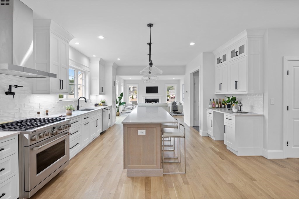 6 Rowell Road Middleton, MA 01949 - Photo 7 of 35 a large kitchen with stainless steel appliances granite countertop a stove oven a sink dishwasher and white cabinets with wooden floor