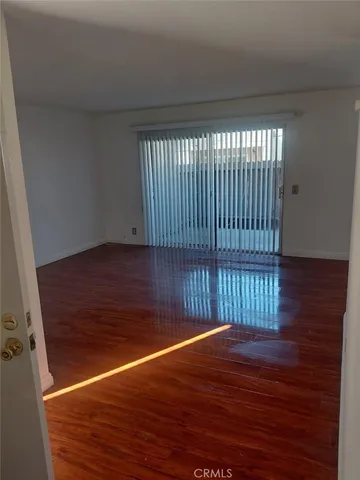 a view of a room with wooden floor and staircase