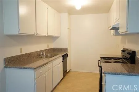 a utility room with sink dryer and washer