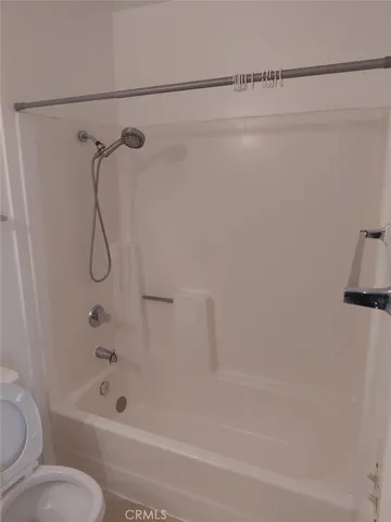 a bathroom with a bath tub with a shower