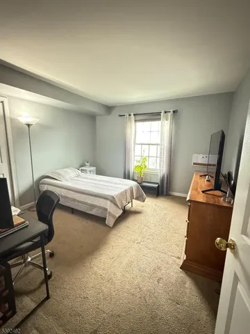 a bedroom with bed and window