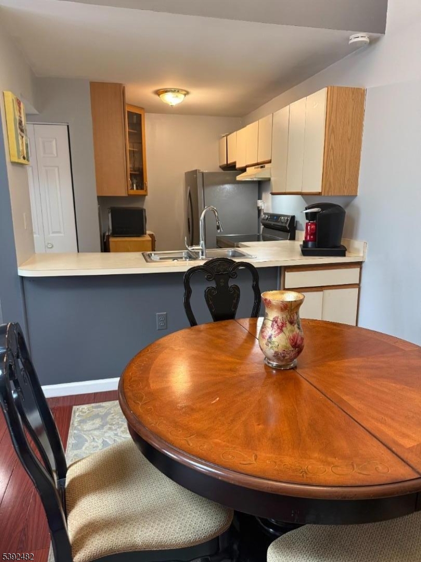 751 Summer Avenue, Unit 3A Newark, NJ 07104 - Photo 5 of 15 a blue kitchen with a table and chairs in it