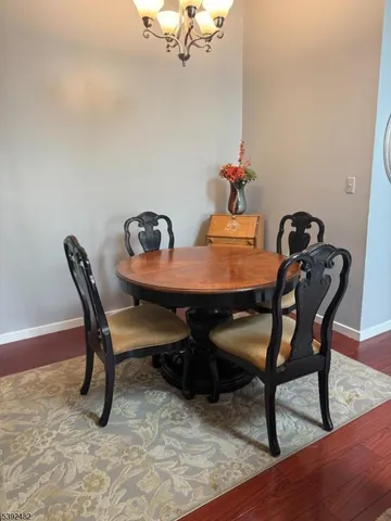 a dining room with furniture and wooden floor