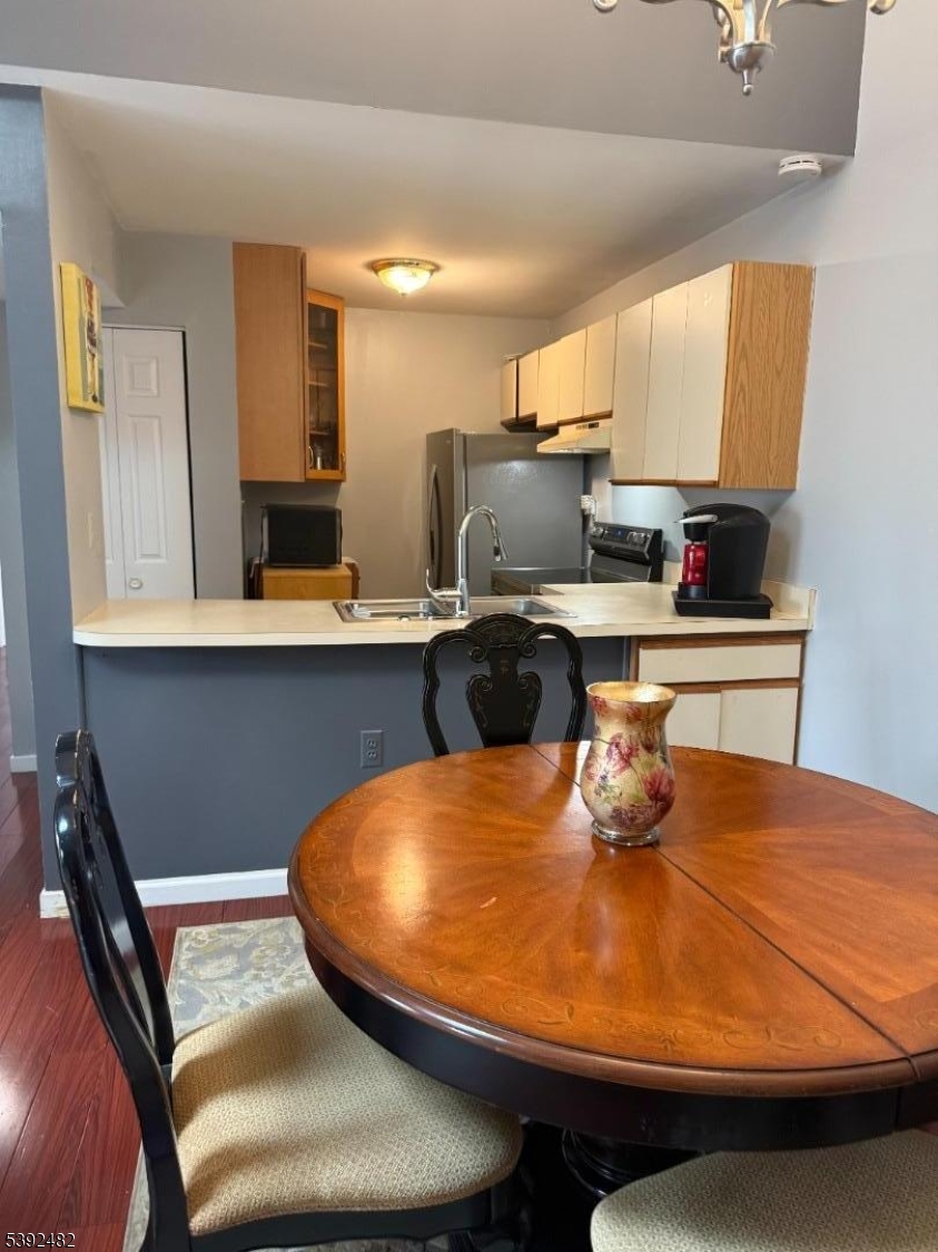 751 Summer Avenue, Unit 3A Newark, NJ 07104 - Photo 7 of 15 a room with a table chairs wooden floor and a view of kitchen