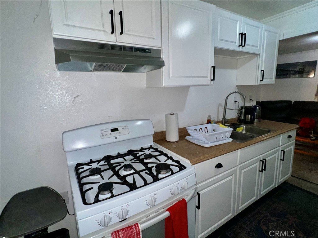 10945-10953 Campbell Avenue Riverside, CA 92505 - Photo 26 of 34 a kitchen with sink a stove and cabinets