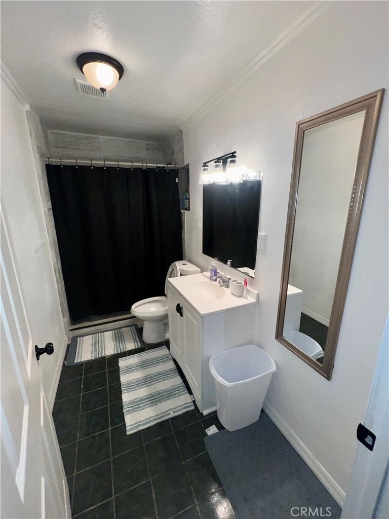 10945-10953 Campbell Avenue Riverside, CA 92505 - Photo 30 of 34 a bathroom with a sink toilet and shower