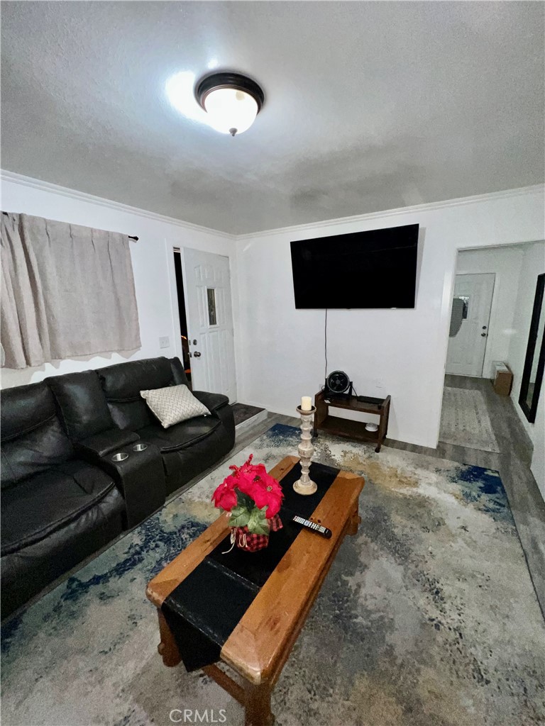 10945-10953 Campbell Avenue Riverside, CA 92505 - Photo 34 of 34 a living room with furniture and a flat screen tv