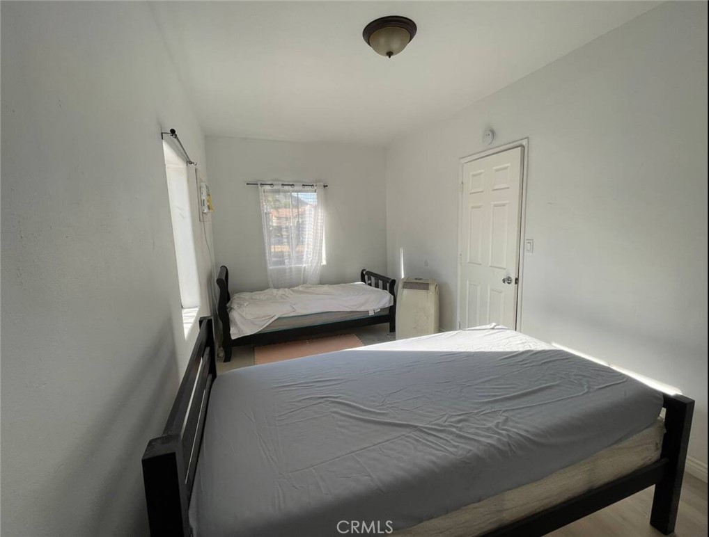 10945-10953 Campbell Avenue Riverside, CA 92505 - Photo 8 of 34 a bedroom with a bed and window