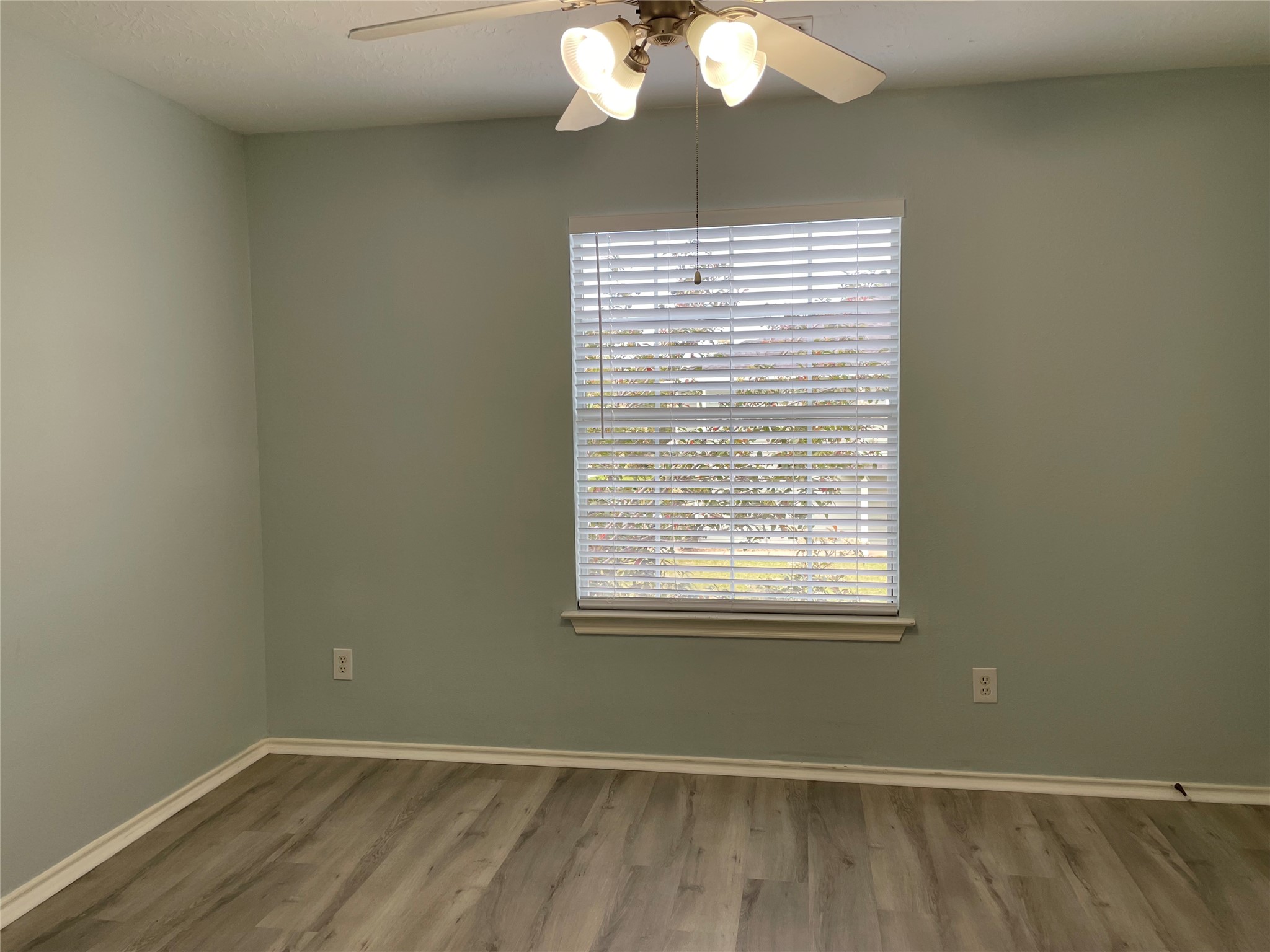 9022 Elm Drake Lane Humble, TX 77338 - Photo 14 of 17 a view of an empty room with wooden floor and a window