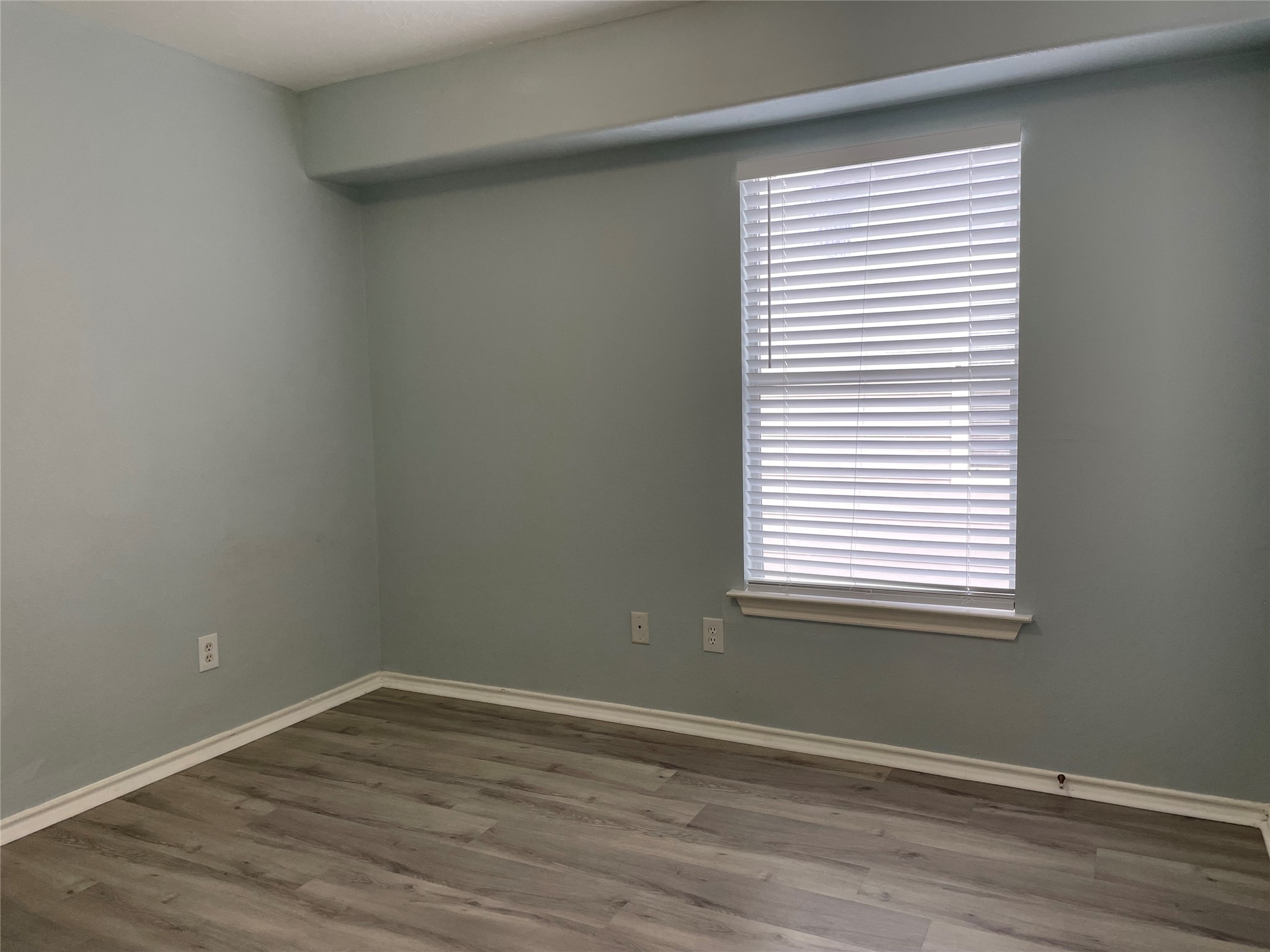 9022 Elm Drake Lane Humble, TX 77338 - Photo 15 of 17 an empty room with wooden floor and a window