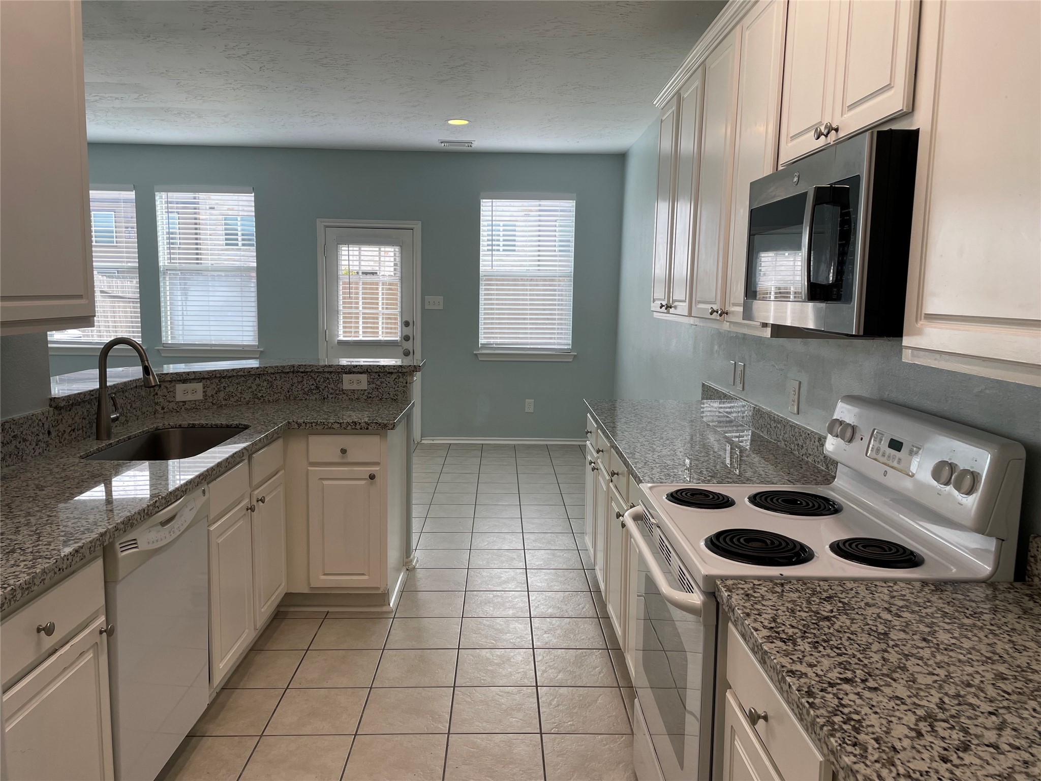 9022 Elm Drake Lane Humble, TX 77338 - Photo 7 of 17 a kitchen with a sink stove top oven and cabinets