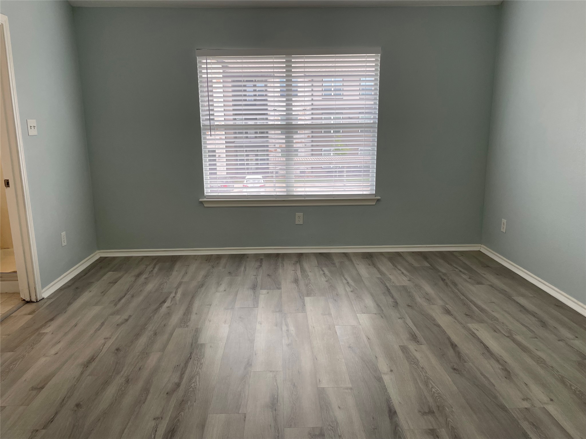 9022 Elm Drake Lane Humble, TX 77338 - Photo 9 of 17 wooden floor in an empty room with a window