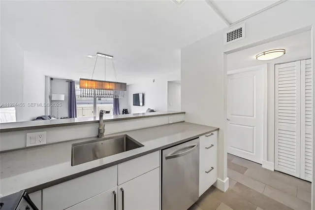 a kitchen with stainless steel appliances granite countertop a sink and a stove