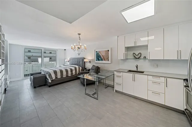 a spacious bedroom with a bed and cabinets