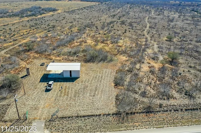 a view of a dry yard with wooden floor