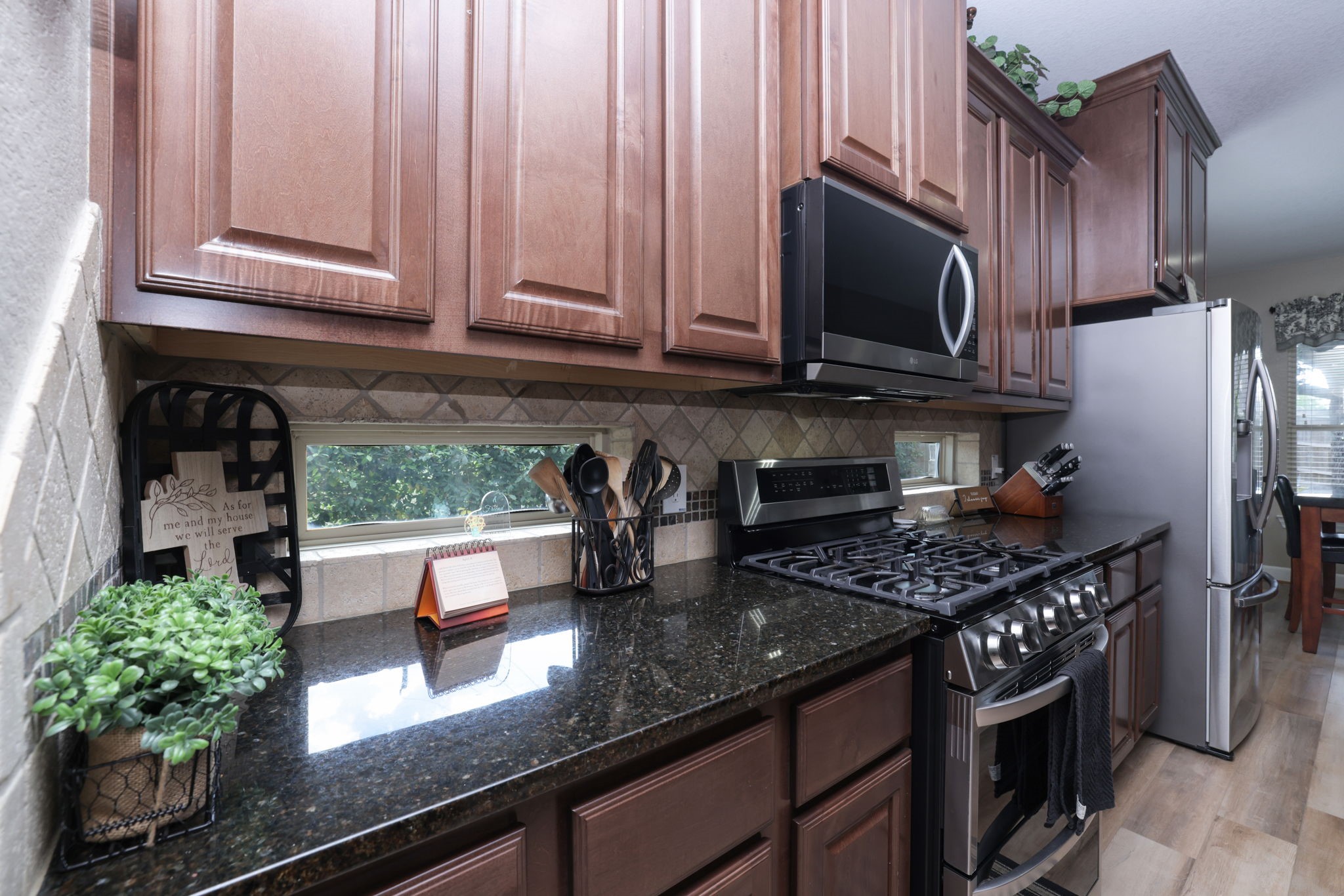 5922 Glen Lief Court Spring, TX 77379 - Photo 12 of 41 a kitchen with stainless steel appliances granite countertop a stove a refrigerator a sink a stove and cabinets