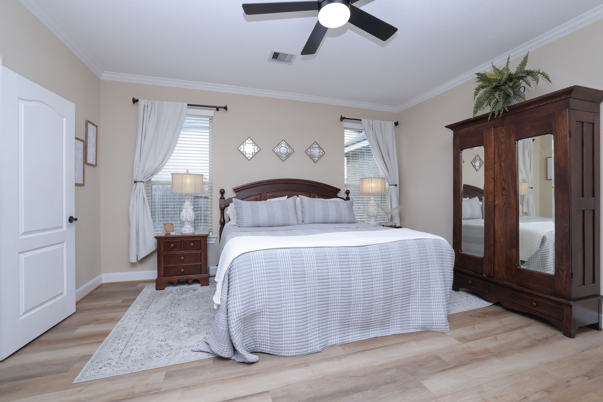 5922 Glen Lief Court Spring, TX 77379 - Photo 20 of 41 a bedroom with a large bed and a chandelier