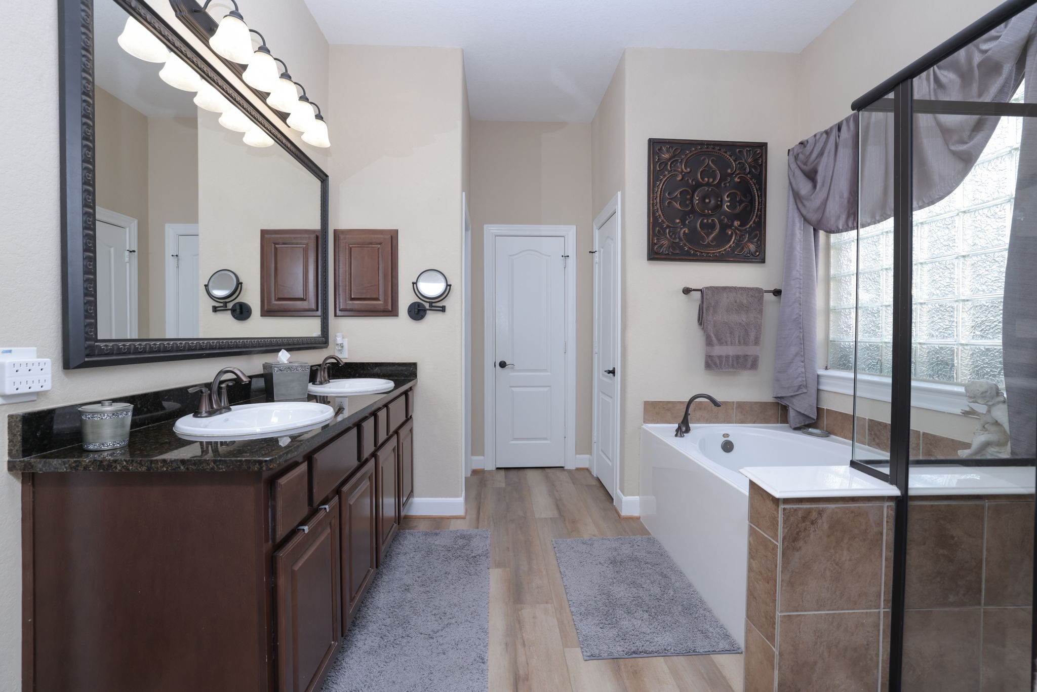 5922 Glen Lief Court Spring, TX 77379 - Photo 22 of 41 a bathroom with a granite countertop sink a mirror a bathtub and shower